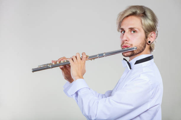 istock Male flutist playing his flute 842187772
