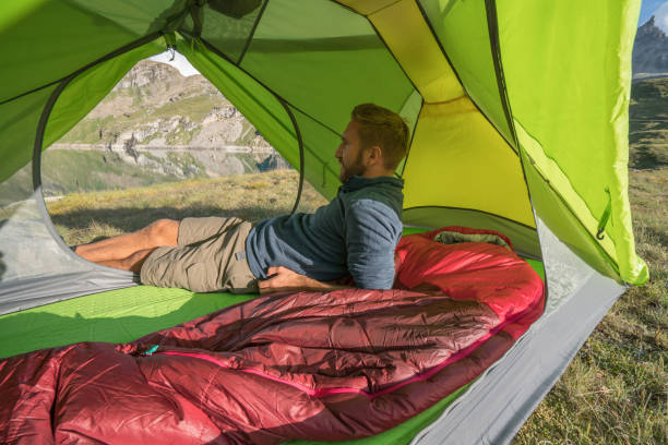 istock Hiker male relaxing in tent 842188238
