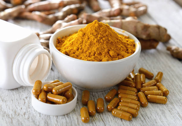 istock Turmeric powder in white cup on wooden floor 842190952