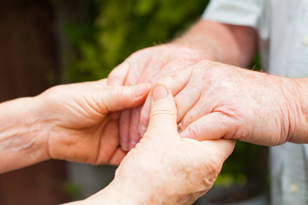 istock Elderly couple holding hands 842192210