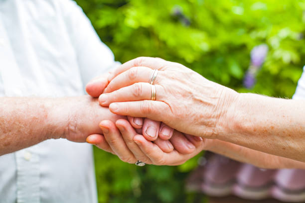 istock Elderly couple holding hands 842192246