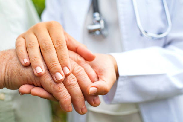 Doctor holding trembling hand stock photo