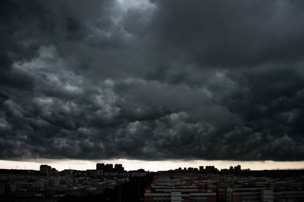 Dark stormy clouds over city.