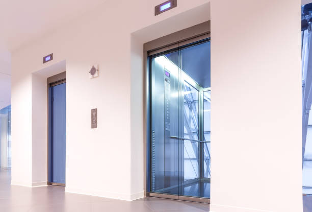 istock Two doors of elevators with transparent walls in modern business building 842196468