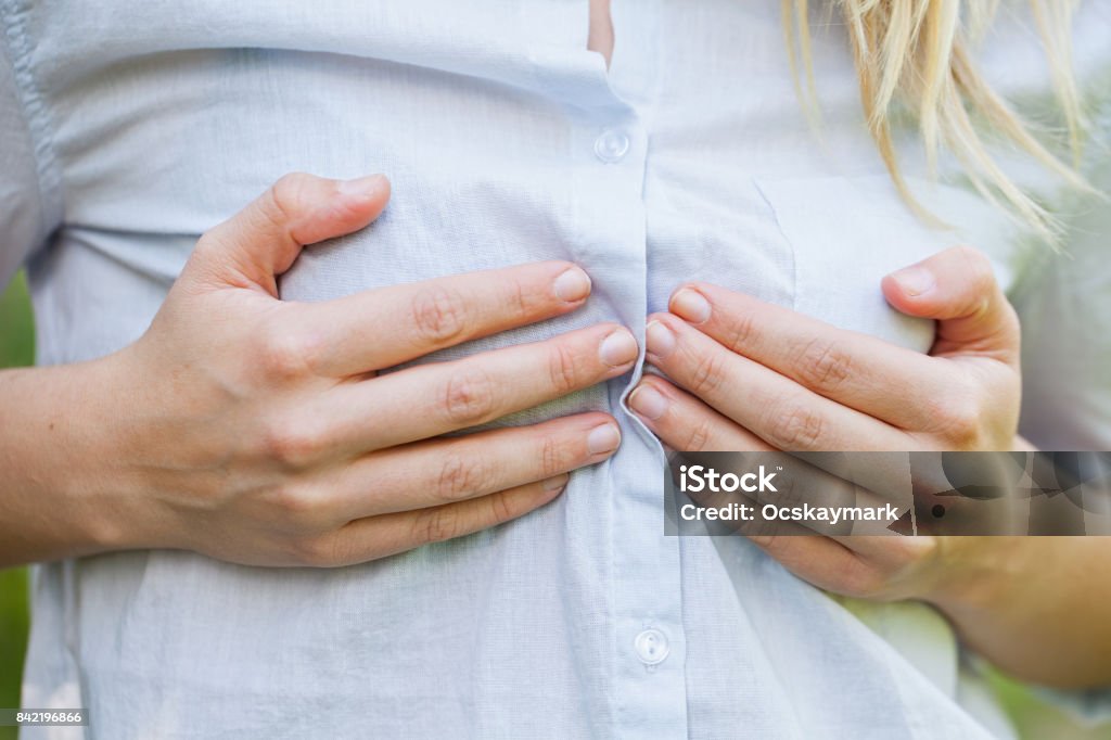 Woman holding her boobs Close up picture of woman holding her breast outdoor Breast Stock Photo