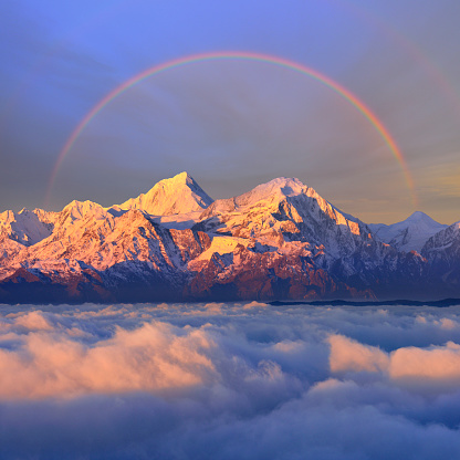 Snowcapped mountain in stratosphere or and rainbow sky at sunrise, Cattle Back Mountain, Sichuan Province, China.