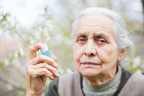 istock Elderly woman having asthma attack, holding a bronchodilator 842206584