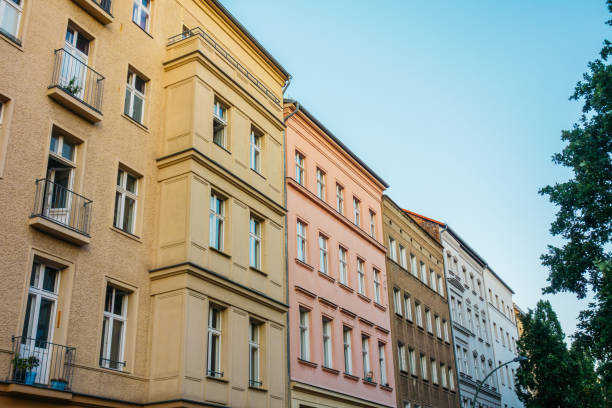 istock brown, yellow and pink houses in a row 842206636