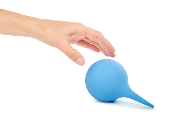 istock female hand holding blue enema ot syringe bulb. Isolated on white background 842206954