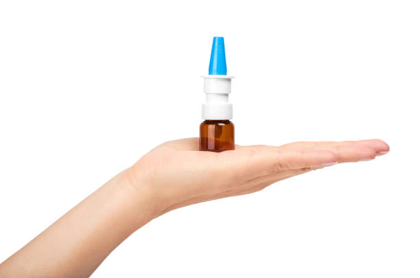 istock female hand holding nose spray bottle. Isolated on white background 842209966