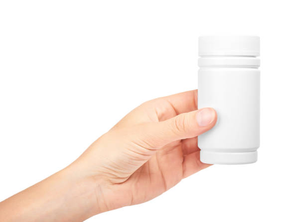 istock female hand holding bottle with pills. Isolated on white background 842209974