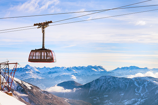 Winter sports travel background with cable car, mountain peaks