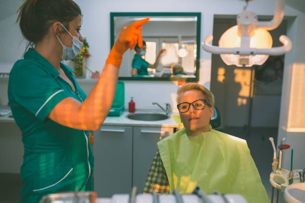 istock Dentist examining a patient's teeth in the dentist. 842210196