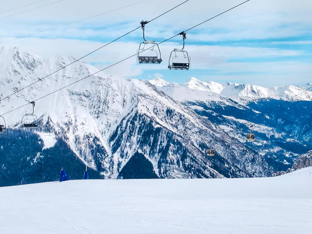 ski lift in the mountains of Chamonix winter resort, French Alps ski lift, slopes and mountains panorama of winter ski resort Chamonix, French Alps chamonix photos stock pictures, royalty-free photos & images