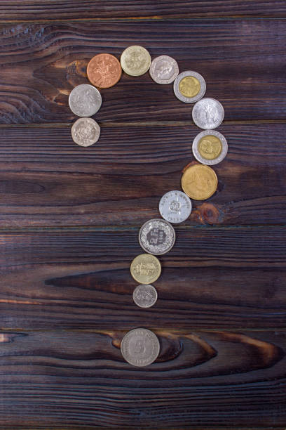 istock question mark from coins of different countries on a wooden background 842210976