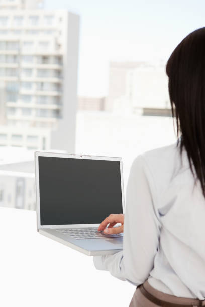 istock Woman with her back to the camera using her laptop 842211186