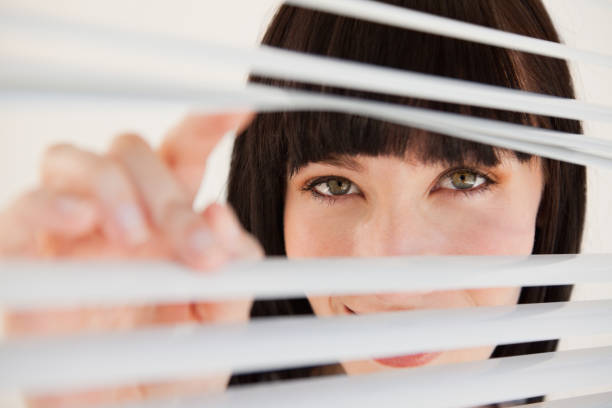 istock Woman moving open some blinds in front of her 842213706