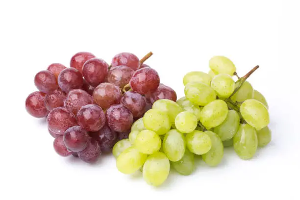 Photo of A bunch of green and red grapes isolated on a white.