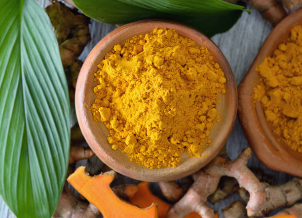 istock Turmeric powder in white cup on wooden 842217720