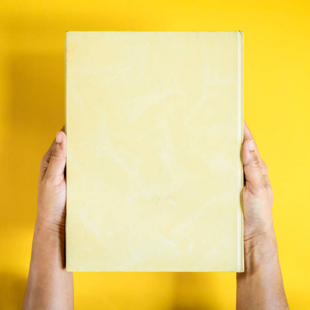 istock top view mock up book on hand and magazine text 842225476