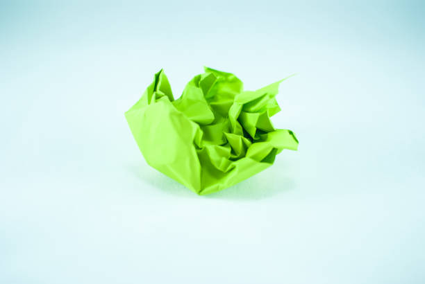 istock Crumpled green paper ball on the white background, isolated 842228242