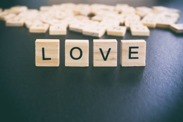 istock Love word on wood block with black backgrounds 842231380