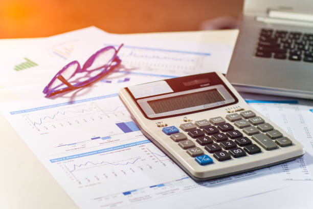 istock Close up business concept, Calculator, glasses and latop on summary report on table office 842231740