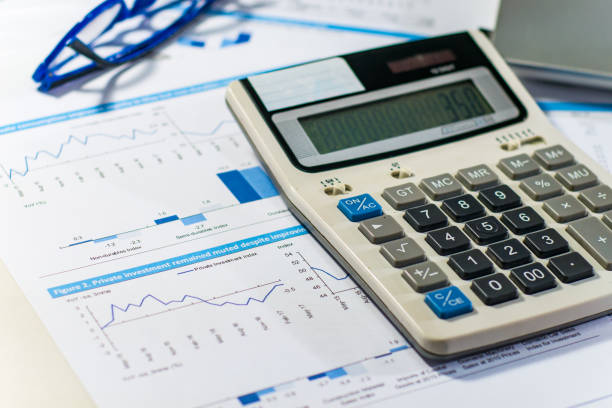istock Close up business concept, Calculator, glasses and latop on summary report on table office 842231762