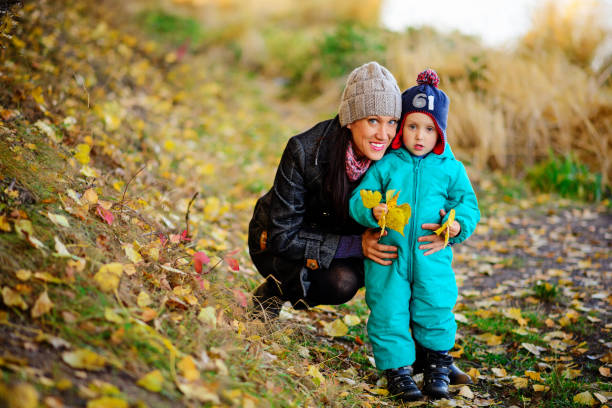 istock Mother with son in autumn peach garden 842231938