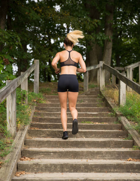 istock Young fit female running up the steps. 842232332