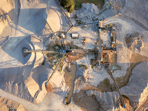 Crushed stone quarry machine at sunset view from above
