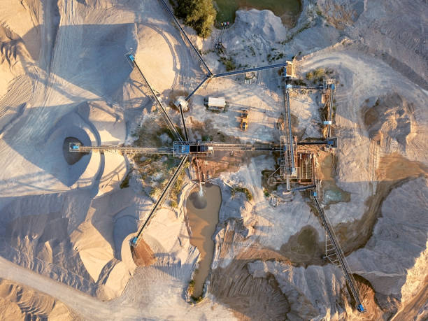 Aerial view of crushed stone quarry machine Crushed stone quarry machine at sunset view from above sand mine stock pictures, royalty-free photos & images