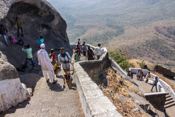 Pilgrims at Mt Girnar Jain Pilgrims are climbing down the 6000 steps from the temple complex at Mt Girnar, at Junagadh, Gujarat, India junagadh stock pictures, royalty-free photos & images