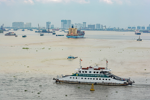 Ho Chi Minh City (Saigon): Commuter ferry crossing the Saigon River with full load of walking and riding passengers.