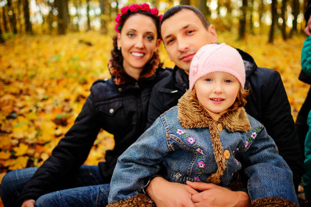 istock Parents look at children in autumn park 842241132