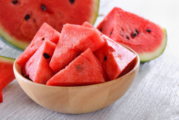 istock water melon in wood bowl on table 842247668