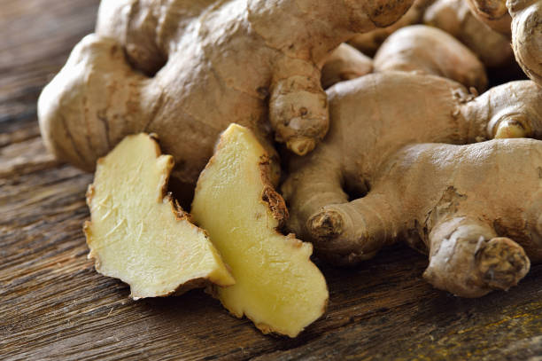 istock ginger sliced in wood bowl 842247808