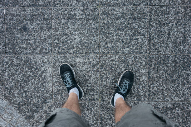 istock man looking down to his shoes on a rainy day 842247888