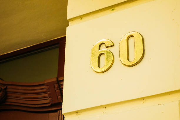 istock number 60 in golden letters on yellow wall 842248204