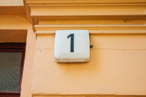 istock number one door sign on orange wall 842260456
