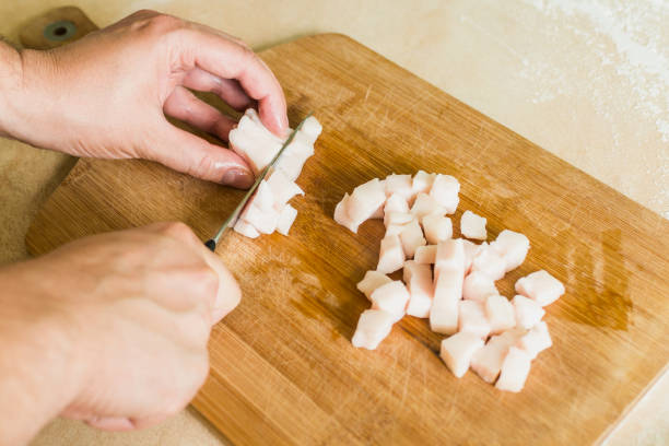 istock a man cuts raw pork fat into pieces 842266676