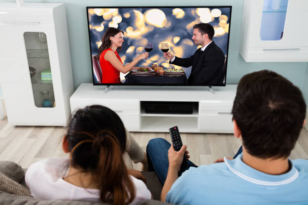istock Young Couple Watching Movie Together 842267838