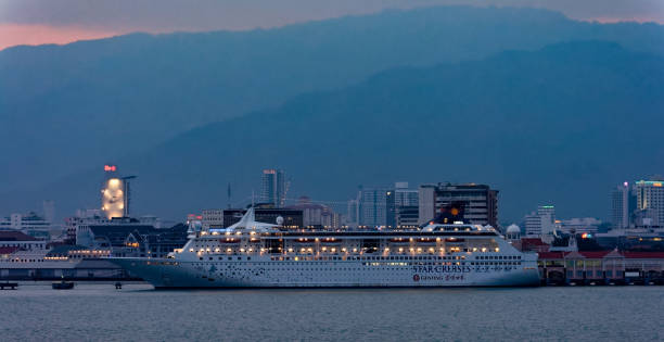 Georgetown: Cruise passenger ship 'Superstar Libra' by Star Cruises with night lights illuminate berthed at Swettenham Pier in the Georgetown harbor.