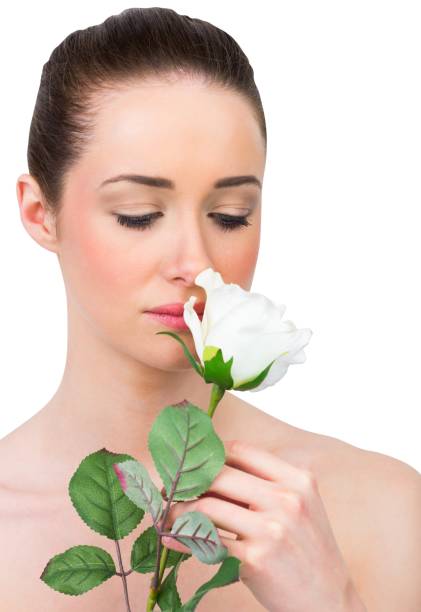 istock Beautiful brunette smelling white rose 842272826