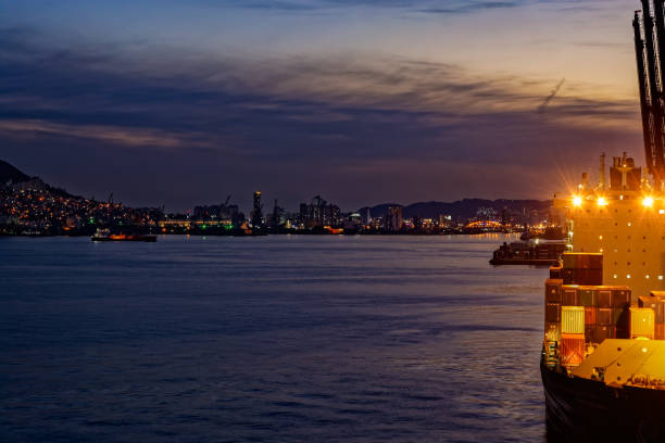 Busan: Night wide angle panorama of cargo vessel in the port of Busan, South Korea, the fifth largest container terminal harbor in the world.