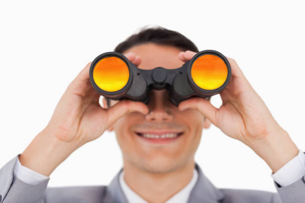 istock Close up of a smiling businessman using binoculars 842277478