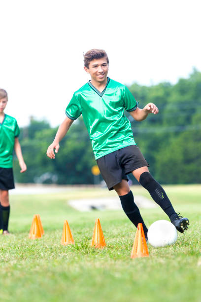 istock Joyful teenage soccer player practices before game 842289924