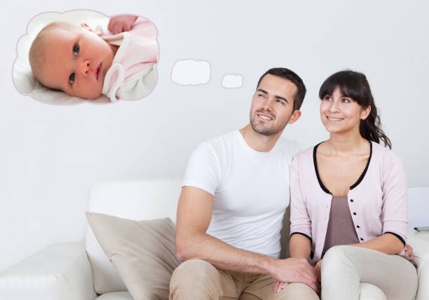 Happy young couple dreaming about the future at home