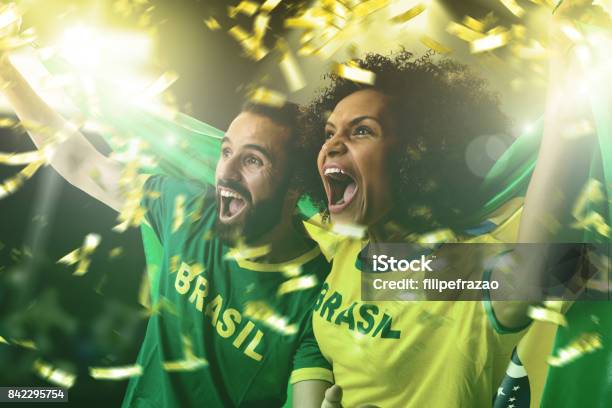 Brazilian Couple Fans Celebrating On White Background Stock Photo - Download Image Now