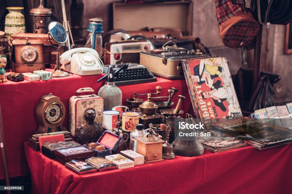 Small group of vintage objects in a flea market Antique watches, magazines, phones, suitcases and other retro products Antique Stock Photo